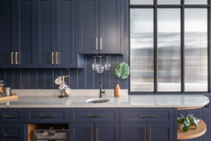 walkin pantry with sink and dark blue cabinets