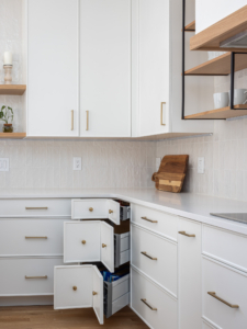 Functional kitchen corner drawer system with fully extended drawers designed to maximize storage and provide easy access to the corner cabinet space.