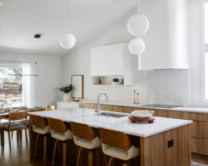 sleek modern Scandinavian kitchen with white pendant globe lights