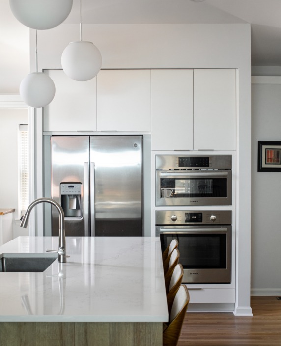 white cabinet fridge surround with stainless steel refrigerator, microwave, and wall oven