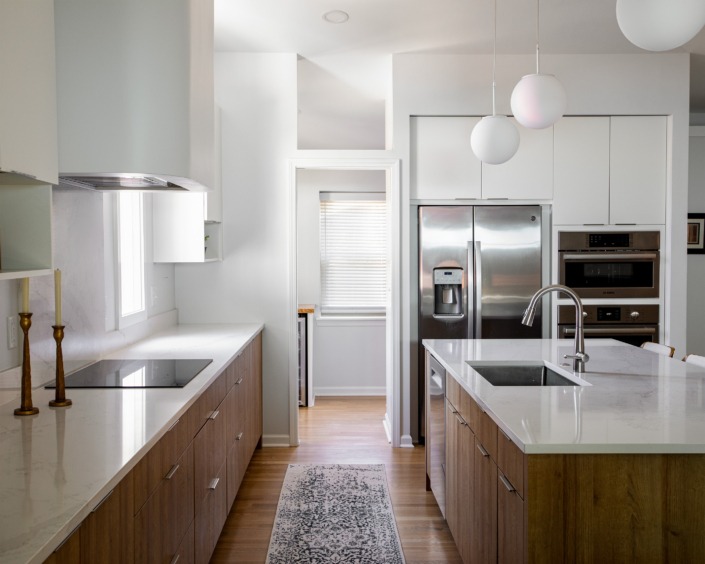 Raleigh kitchen remodel with lots of natural light and a doorway at the end of the walkway leading to a walk in pantry