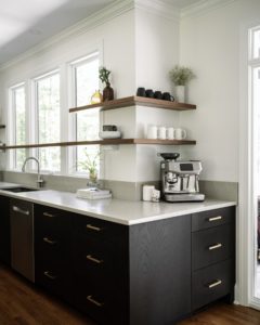 a_11 Kitchen coffee station with black cabinets, white quartz countertops, floating wood shelves, and large windows.