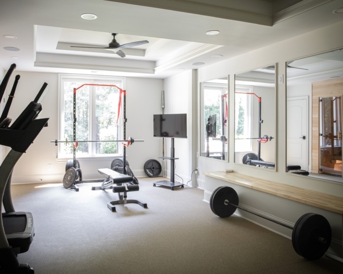 Wakefield_IMG_0006 (2) Spacious in-home basement gym with strength and cardio equipment, wall mirrors, abundant natural light, and an adjoining private sauna.