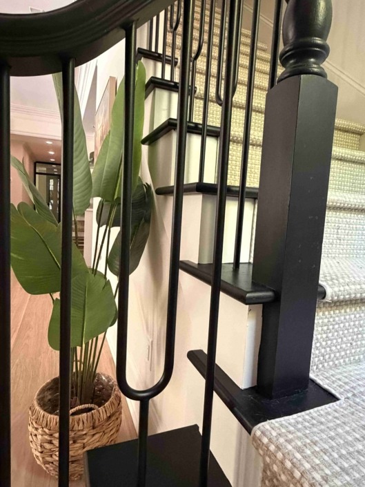 wakefield IMG_1470 Modern staircase featuring painted wood treads and custom black painted wood railing with decorative geometric picket details.