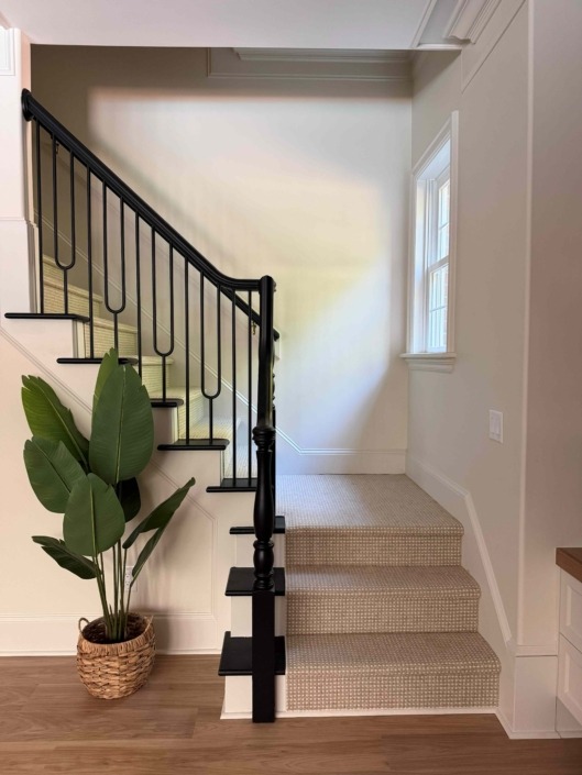 wakefield IMG_1472 Modern staircase featuring painted wood treads and custom black painted wood railing with decorative geometric picket details.